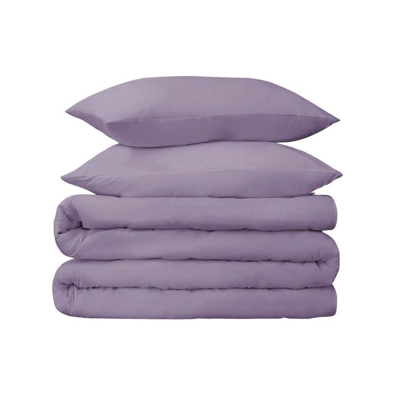 Lavender cotton duvet cover set with two matching shams, folded with pillows