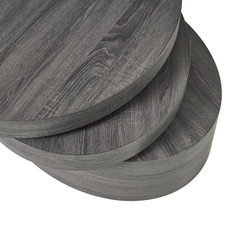 Side view of the drum coffee table showing stacked rings and dark gray wood finish.