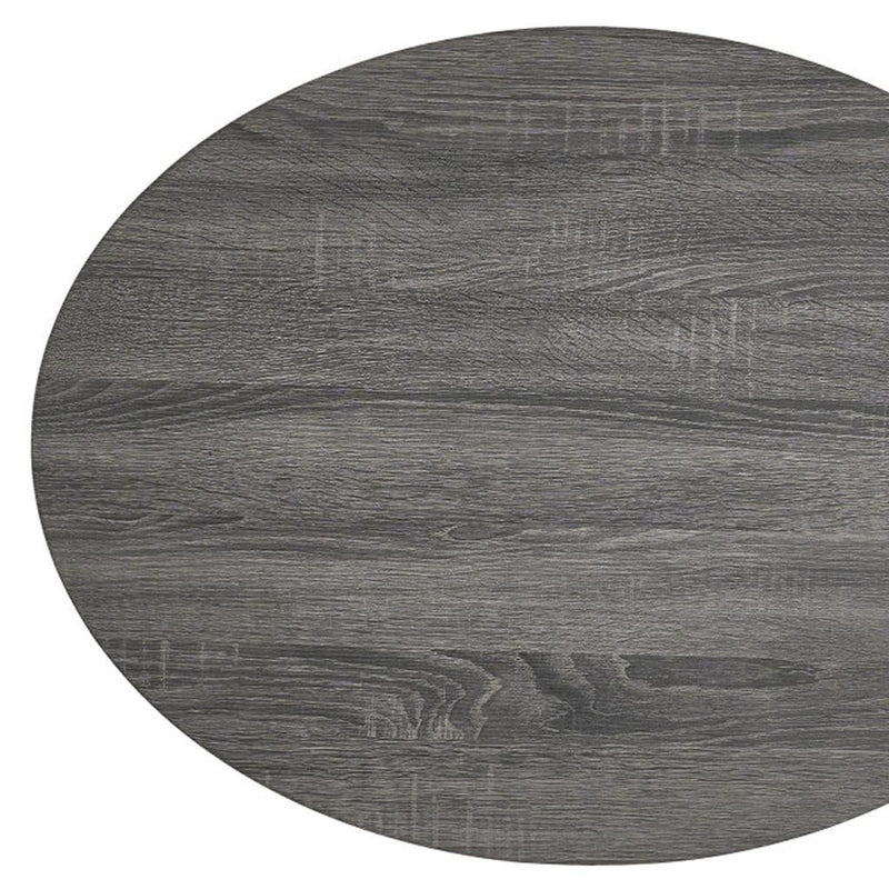 Detailed view of the round tabletop surface with dark gray wood grain and knots.