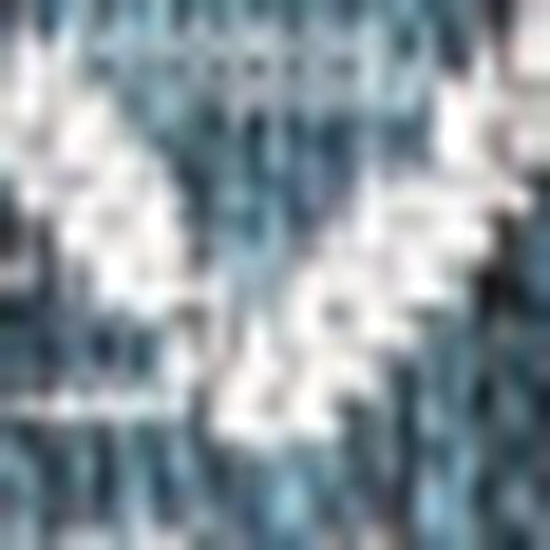 Teal blue area rug with white geometric trellis motif, close-up