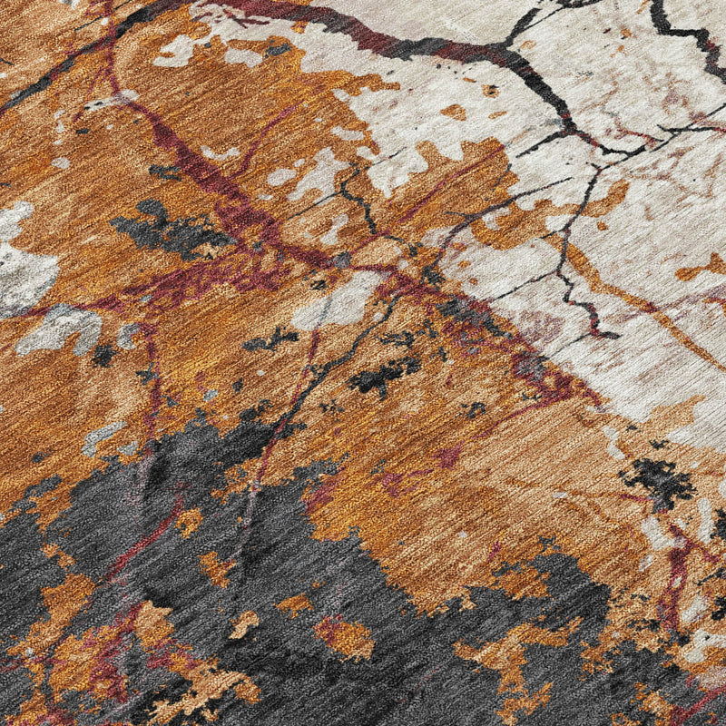 Abstract rug close-up with copper-orange, gray, and cream distressed blocks and lines.