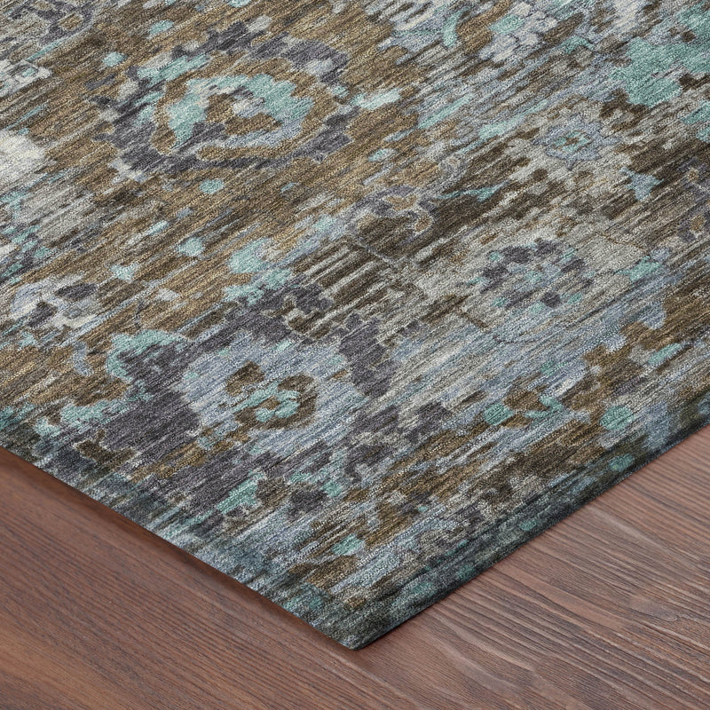 Corner view of indoor outdoor area rug with distressed teal and brown floral pattern