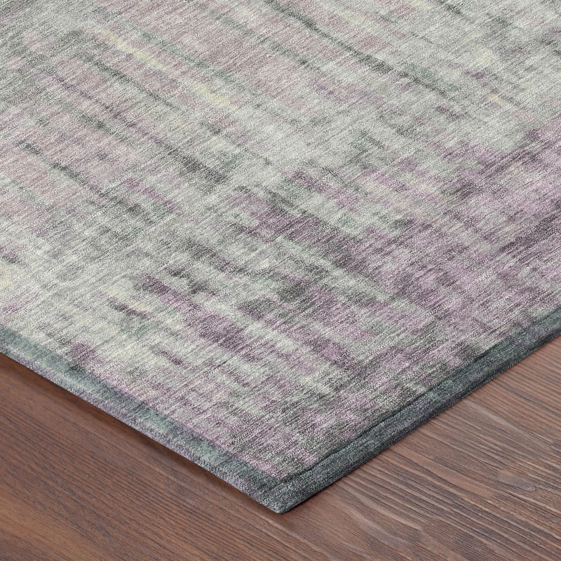 Corner view of lavender and plum abstract washable area rug, flat weave with streaks.