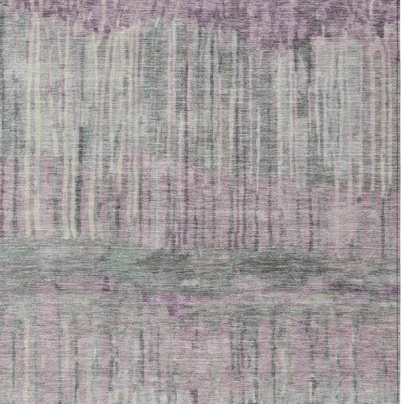 Lavender and plum abstract area rug close-up with distressed streaks and mottled texture.