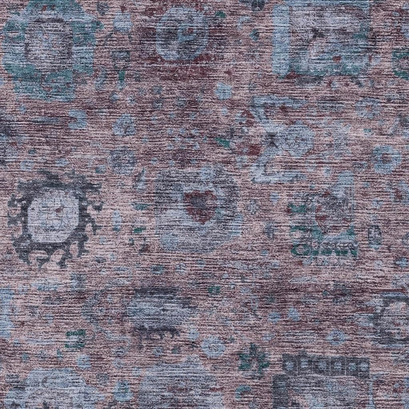 Close-up of abstract rug texture with purple-plum background and blue-gray distressed marks