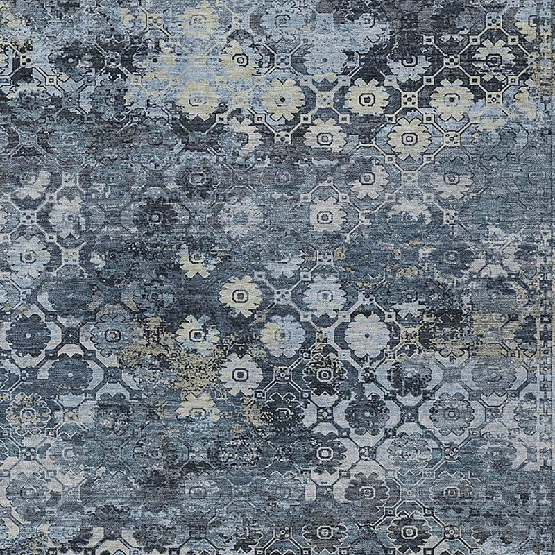 Close-up blue abstract rug with distressed geometric medallion pattern