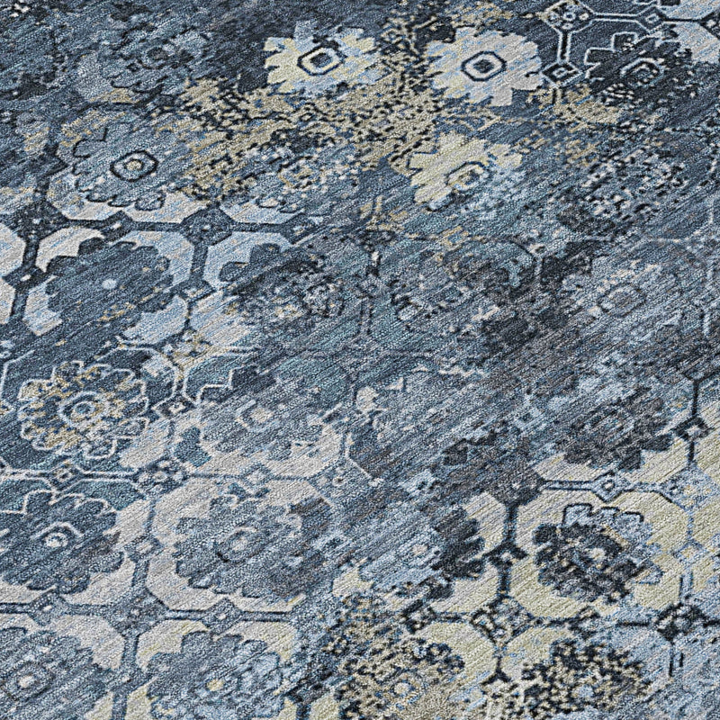 Close-up of light and dark blue abstract area rug with distressed motifs