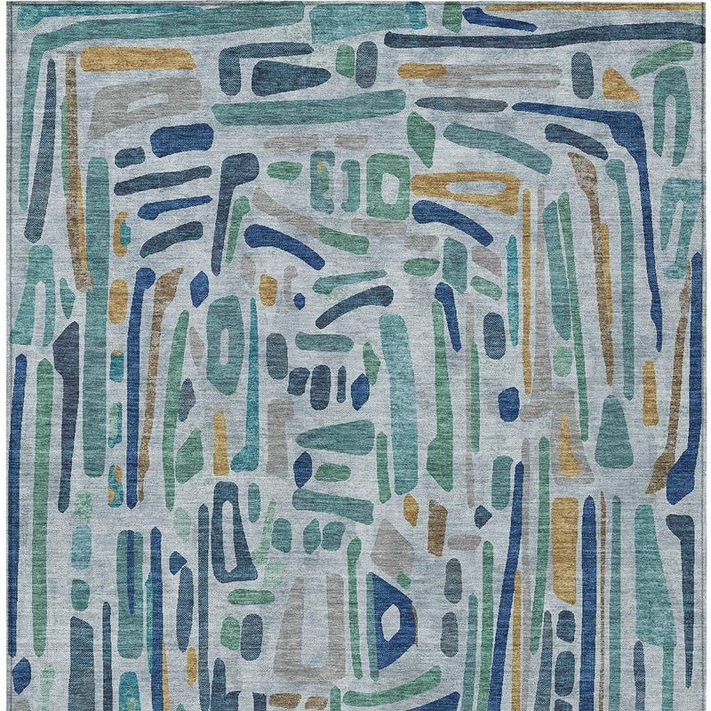 Abstract area rug close-up, teal and blue drips with beige accents