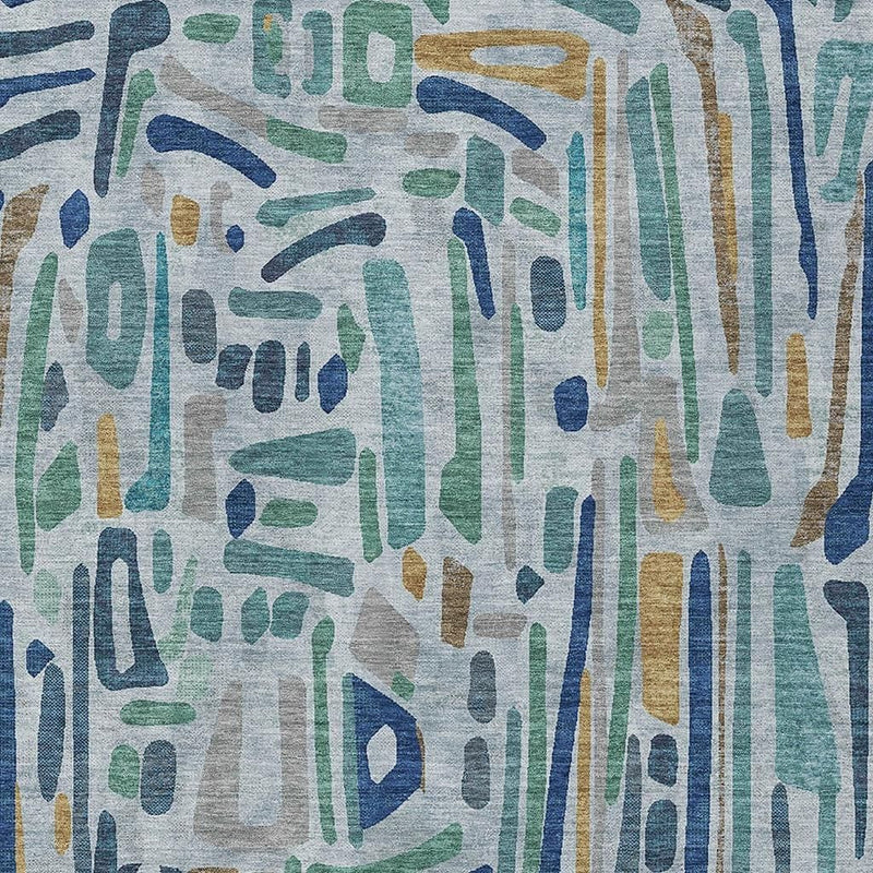 Abstract area rug close-up with teal, navy, green, and tan dripped lines