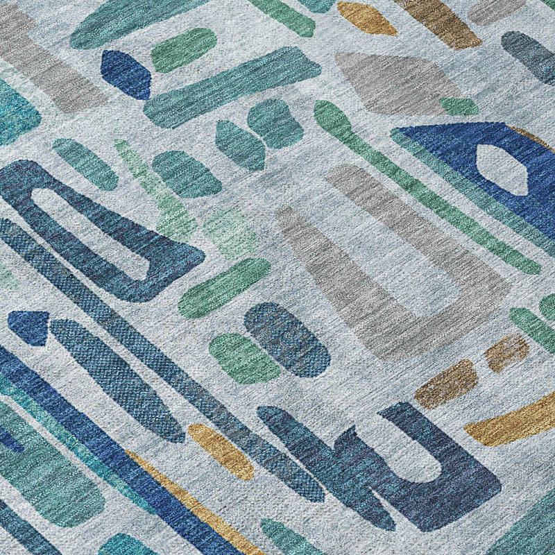 Abstract area rug close-up with aqua and teal shapes plus navy striped marks