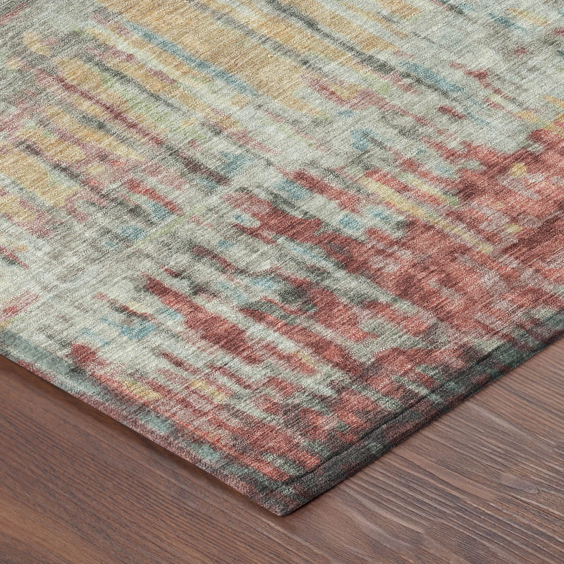 Round abstract area rug, corner view, washed stripes in coral, sage, blue, and gold.