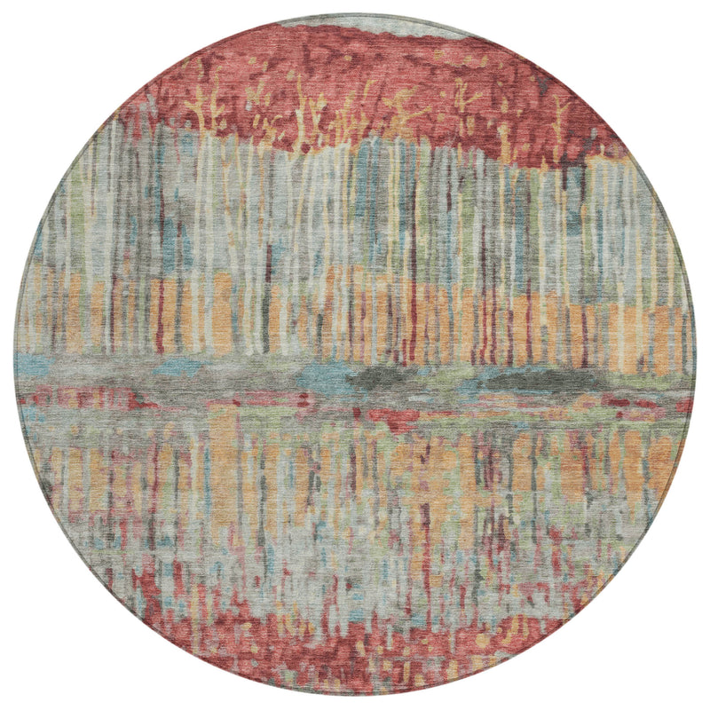 Round abstract area rug with coral, sage, blue, and gold washed vertical lines.