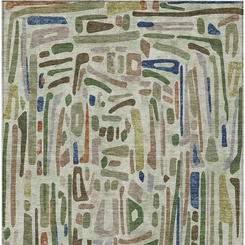 Abstract green and olive area rug with layered paint-like shapes and blue accents