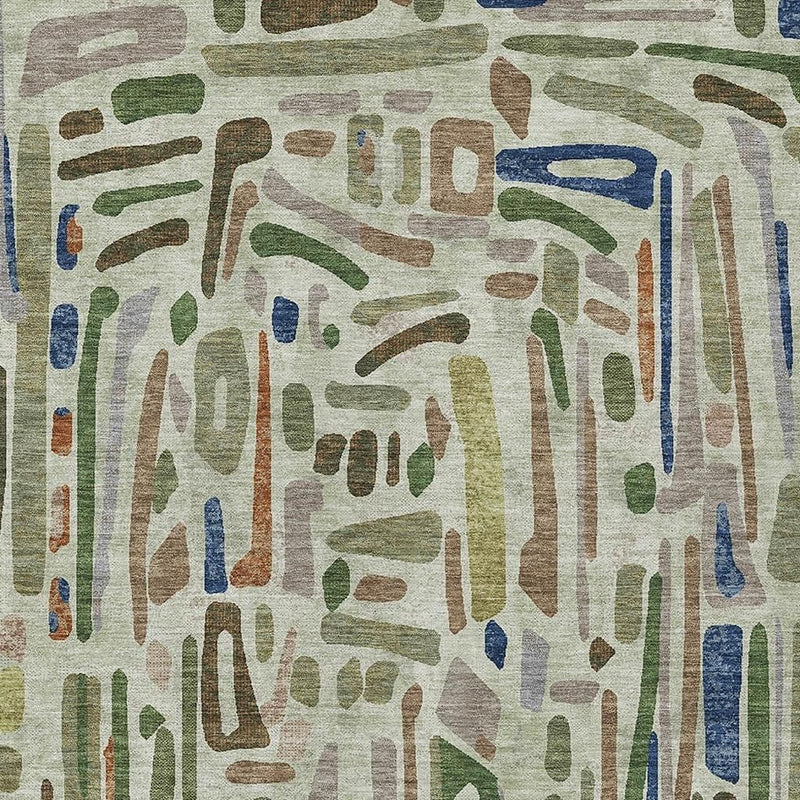 Abstract indoor/outdoor area rug with green, blue, and brown drip pattern on cream.
