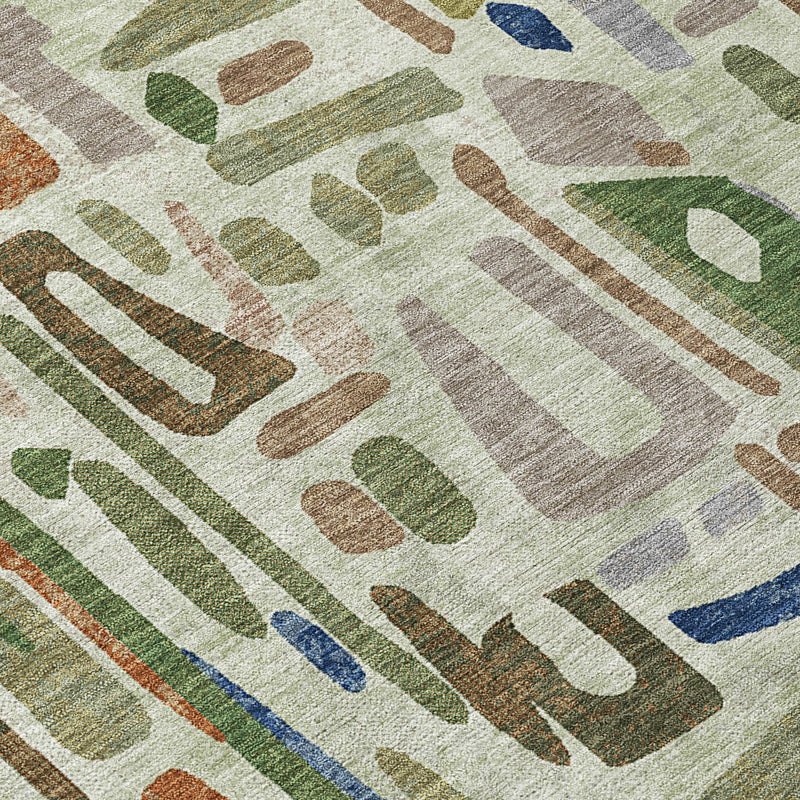 Corner view of green abstract area rug with olive and blue shapes on cream.