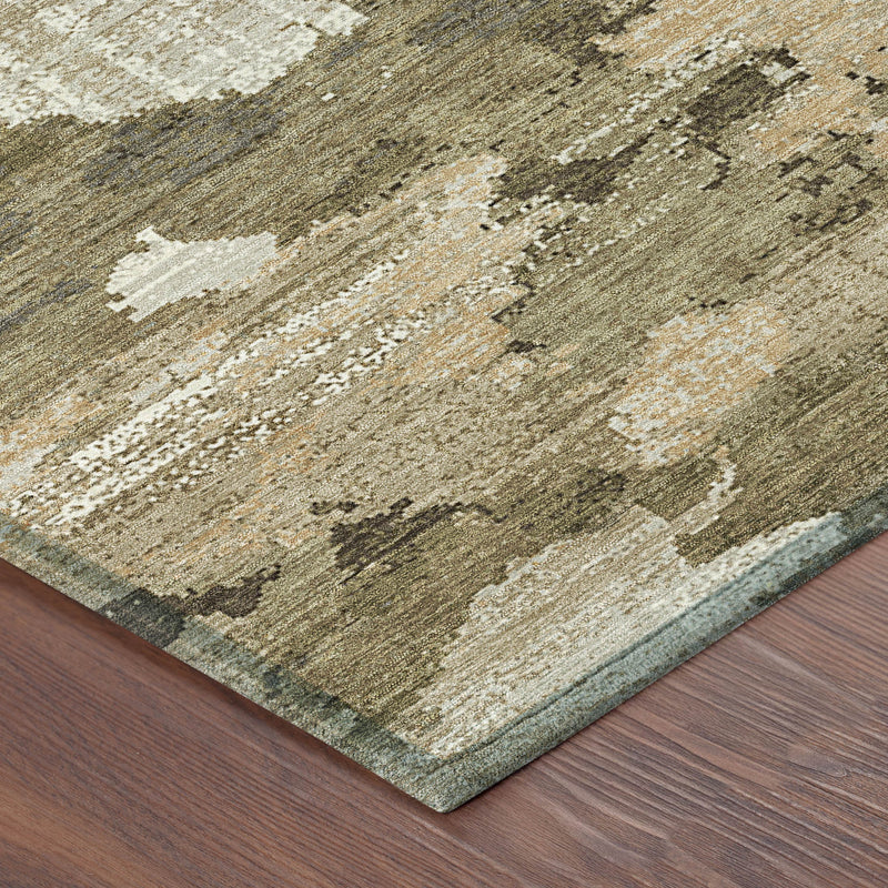 Khaki and beige abstract area rug corner with distressed texture and flat pile.