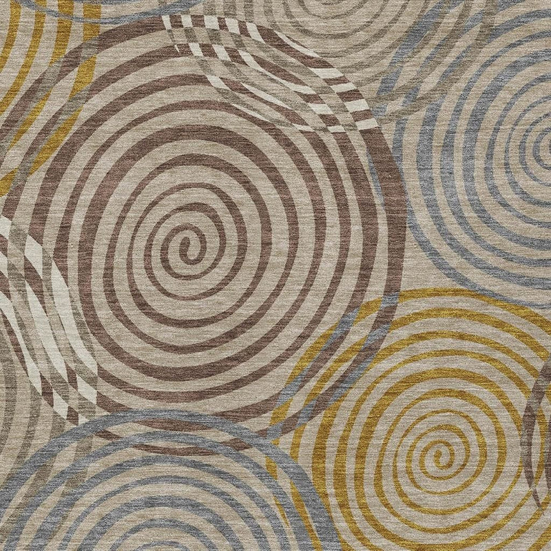 Close-up geometric swirl area rug in beige, brown, blue, and gold hues