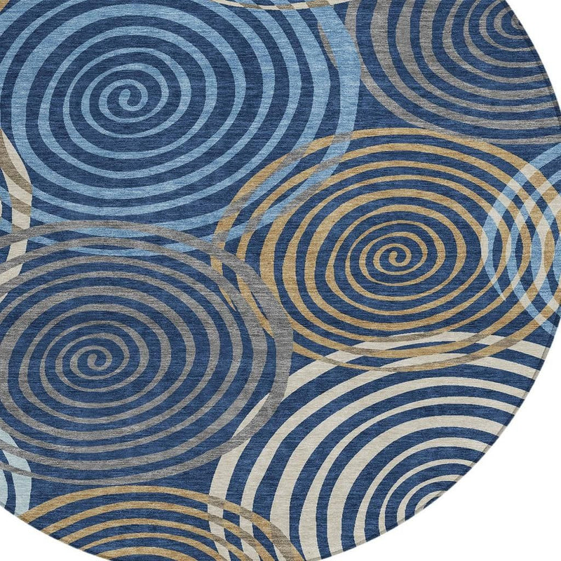 Round area rug close-up: blue spiral rings with tan geometric highlights
