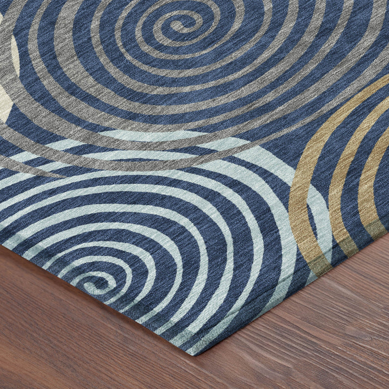 Corner of round area rug with blue concentric rings and tan highlight accents
