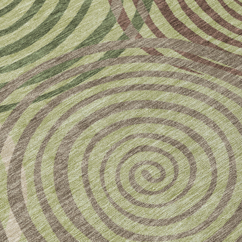 Area rug close-up with concentric spiral rings in green, gray, and taupe