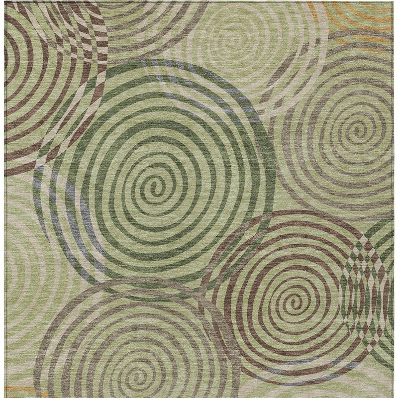 Rectangular geometric area rug with overlapping spiral circles in green and olive tones