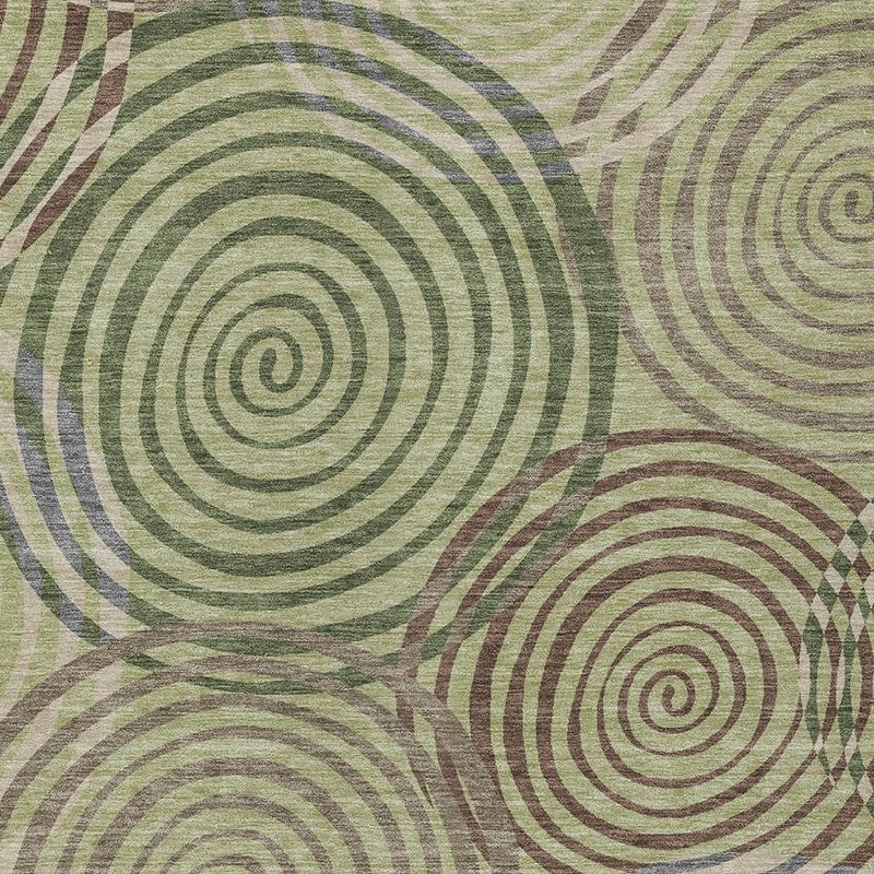 Geometric area rug close-up featuring spiral circle pattern in muted greens and taupe
