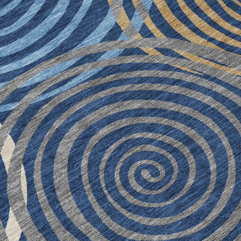 Geometric area rug close-up with blue, gray and beige striped spiral circles