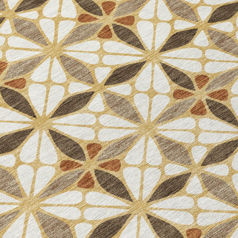 Geometric area rug close-up of starburst pattern in cream, gold, and terracotta accents
