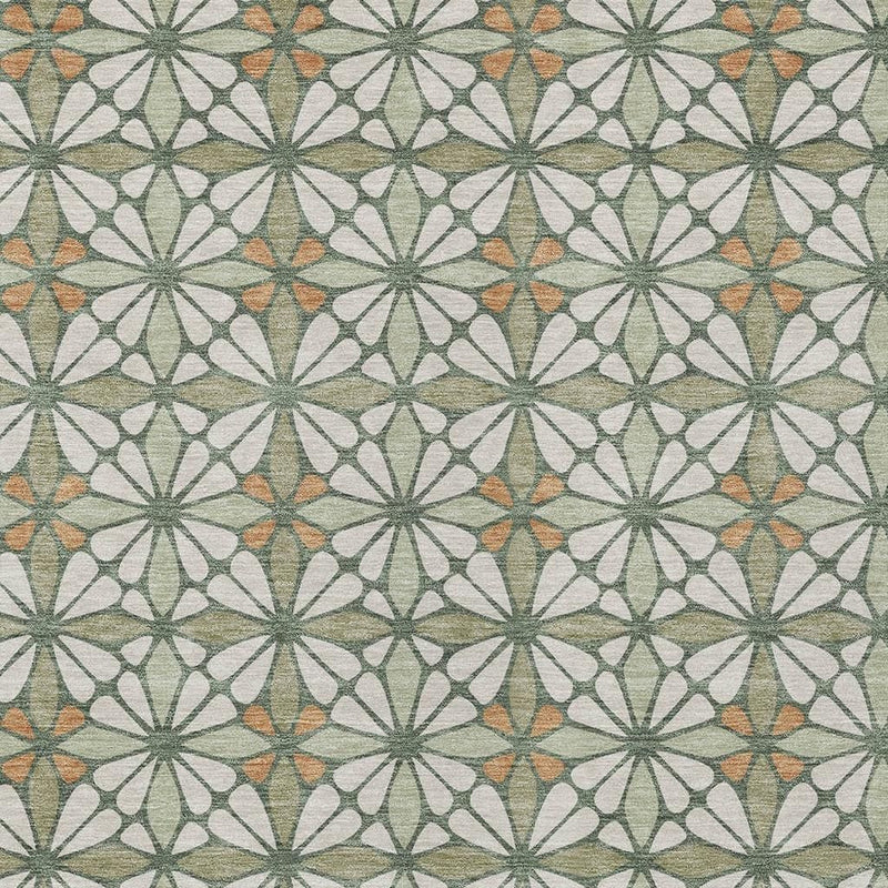 Geometric area rug texture and pattern close-up with green starbursts and small orange touches