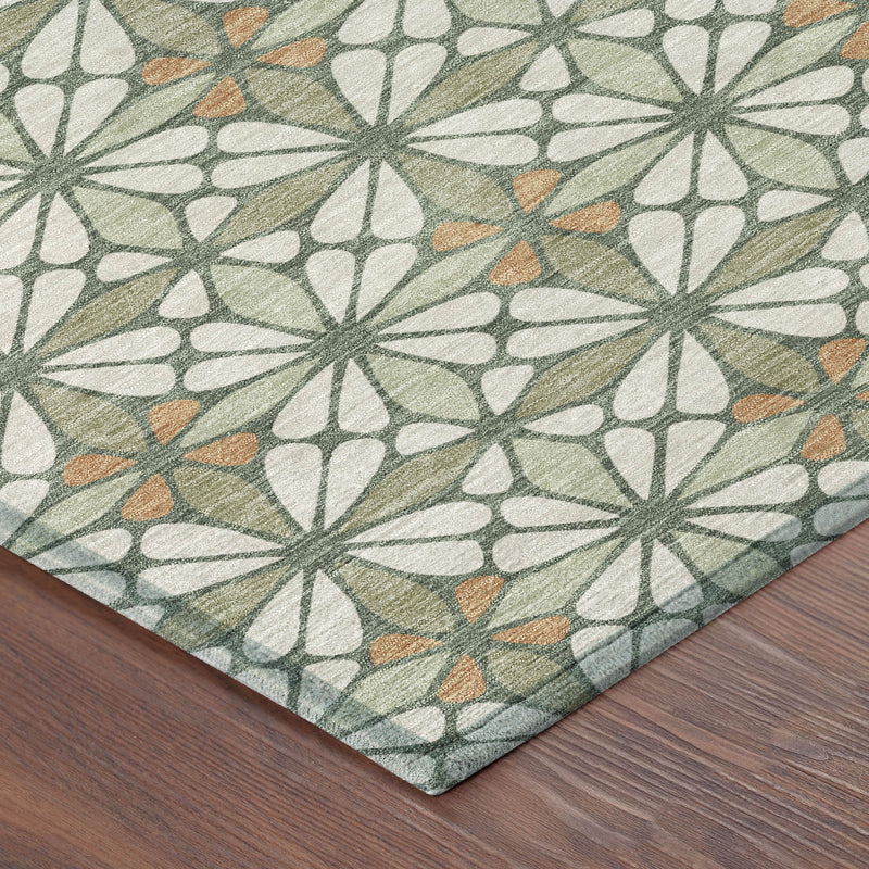 Geometric area rug corner detail, cream background with green and orange starburst shapes