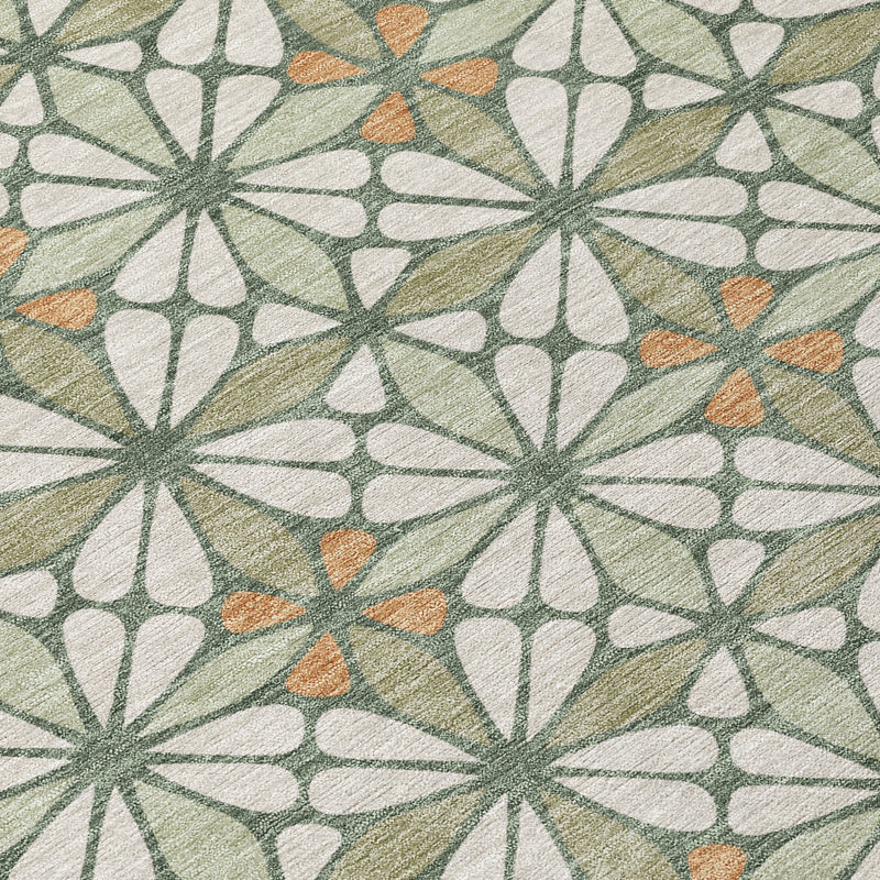 Geometric area rug fabric close-up showing cream shapes with muted green and orange details