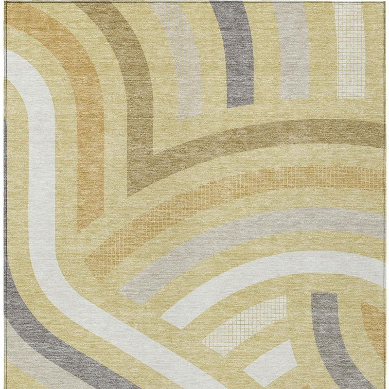 Abstract area rug surface with sweeping curved bands in wheat, gold, gray, and white.