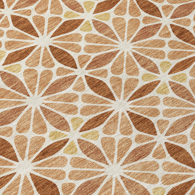 Close-up of copper and gold rug with white starburst and outlined petal shapes.