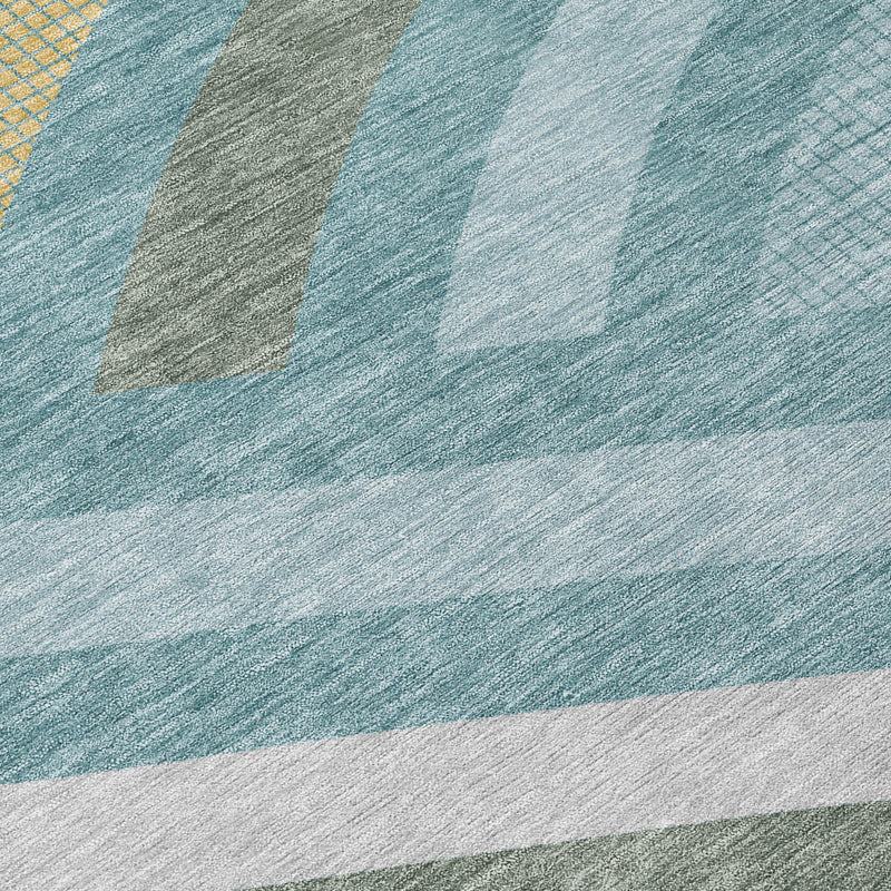 Close-up teal blue abstract area rug with textured white and gold stripe details