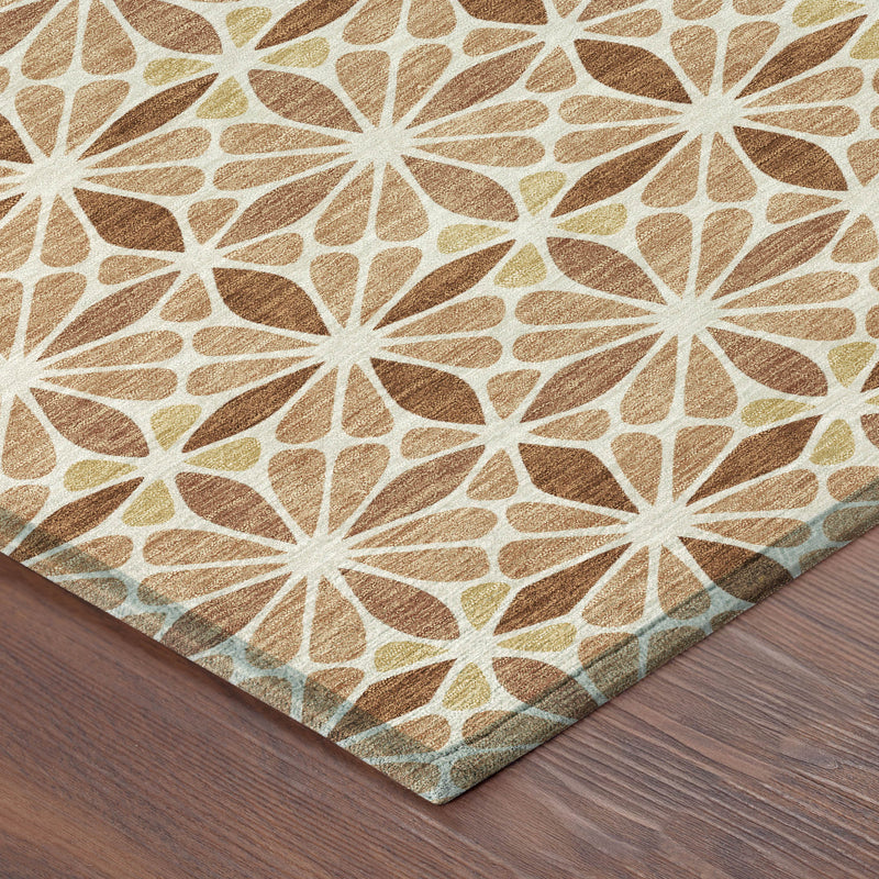 Corner of copper and gold geometric rug with white starburst pattern and folded edge.