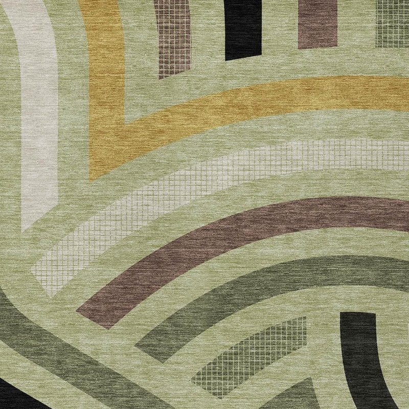 Close-up of abstract area rug texture with curved bands in green, tan, brown, and black.