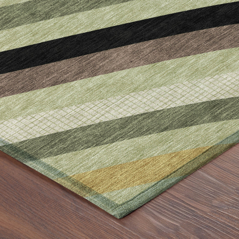 Abstract area rug corner on wood floor, featuring green, olive, tan, brown, and black stripes.