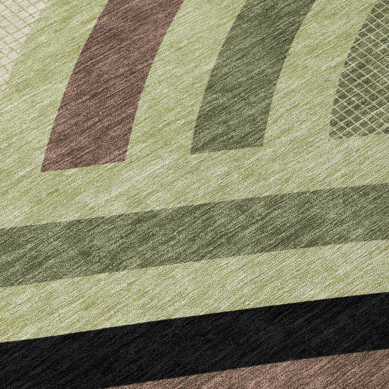 Abstract area rug close-up with zigzag and banded pattern in green, olive, tan, and brown.