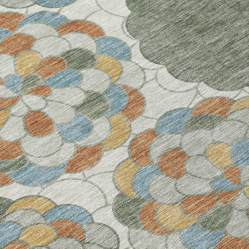 Close-up of floral area rug pattern with blue, orange and gray flower clusters