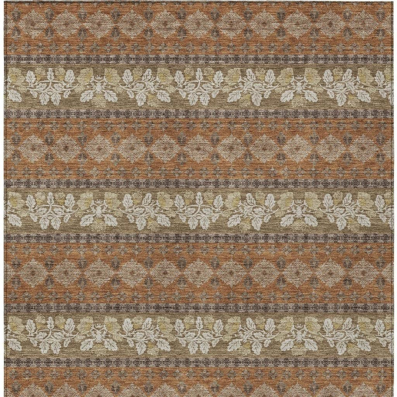 Rectangular striped area rug in burnt orange and beige with gray diamond-texture pattern