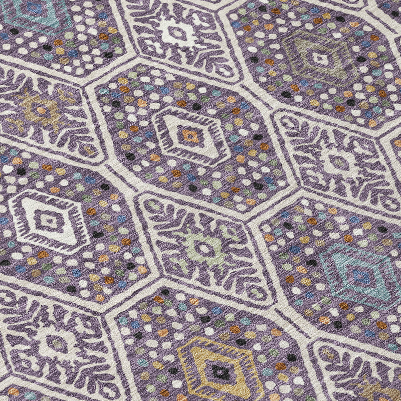 Geometric area rug close-up with hexagons, dots, and medallion motifs in purple and blue