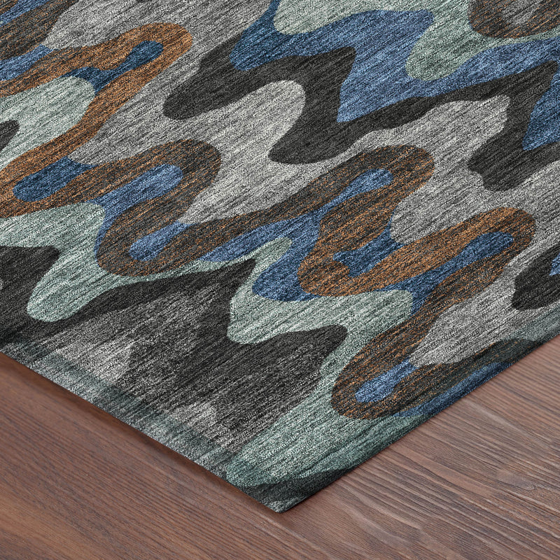 Corner view of abstract area rug with zigzag waves in gray, blue, and rust orange