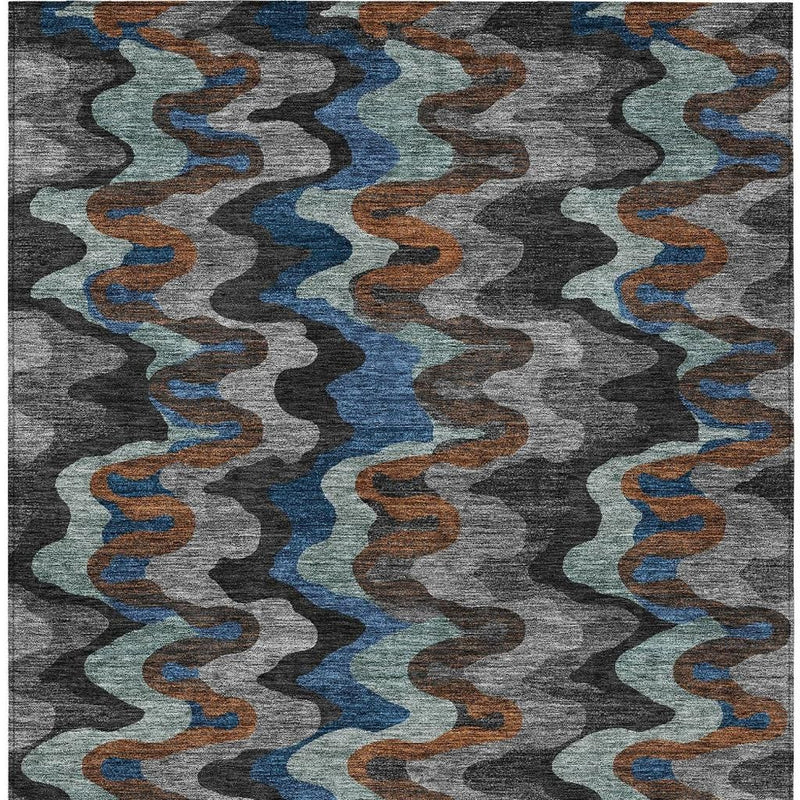 Top view of abstract area rug with repeating wavy stripes in gray, blue, and orange
