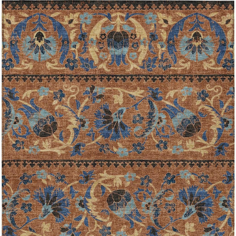 Indoor outdoor area rug close-up, blue and tan floral pattern with border trim