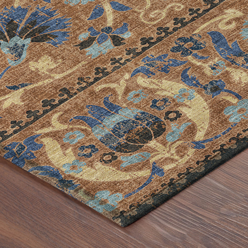 Indoor outdoor area rug corner, blue and tan ornate floral design on wood floor
