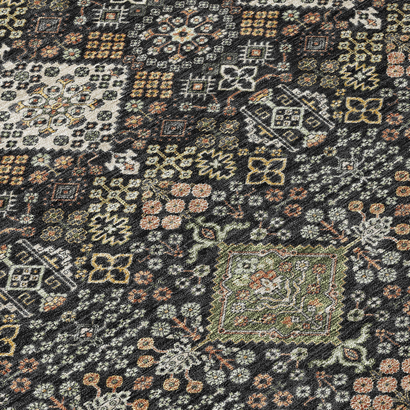 Geometric area rug close-up: dark charcoal base with multicolor ornamental motifs