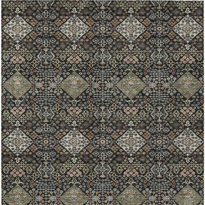 Geometric area rug pattern: dark charcoal base with beige, gold, and muted orange