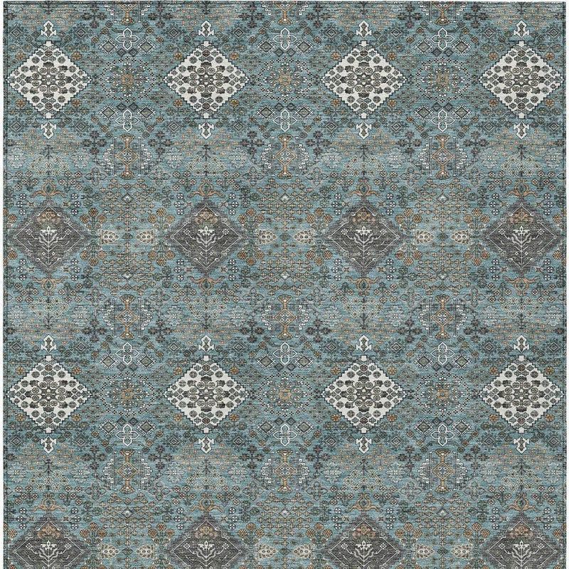 Teal blue and ivory geometric area rug with repeating diamond medallions, close full view