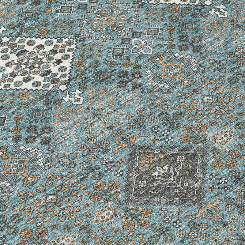 Teal blue and ivory geometric rug with distressed accents, textured close-up