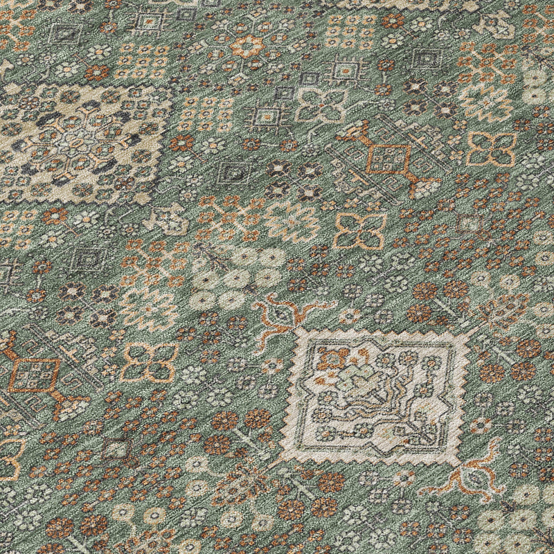 Geometric area rug close-up in green with multicolor diamond and floral motifs.
